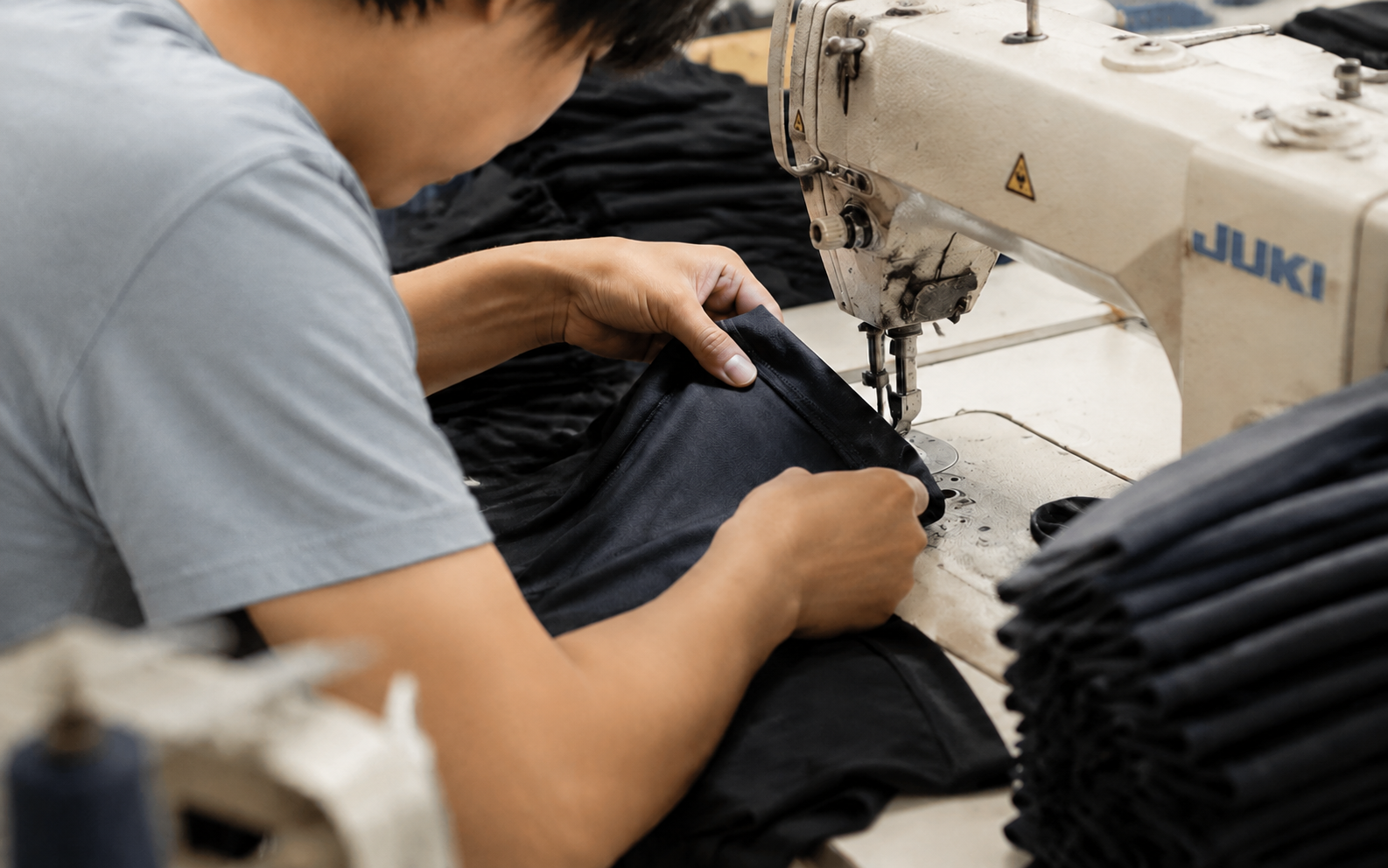 Operator inspecting seams and workmanship of men's underwear during sewing production